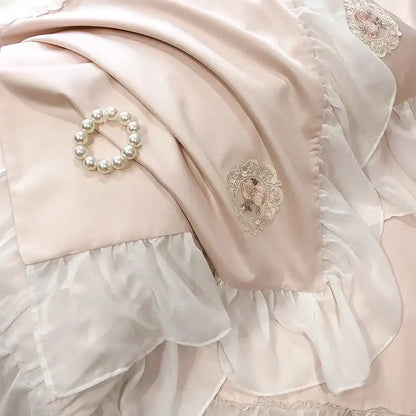A delicate pearl bracelet on blush pink satin with french lace ruffles in a decorbites french lace bedding set