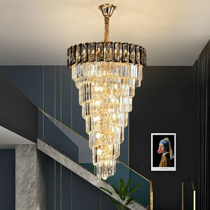 French luxury amber crystal chandelier with multi-tiered clear and black prisms suspended by gold chain for living room