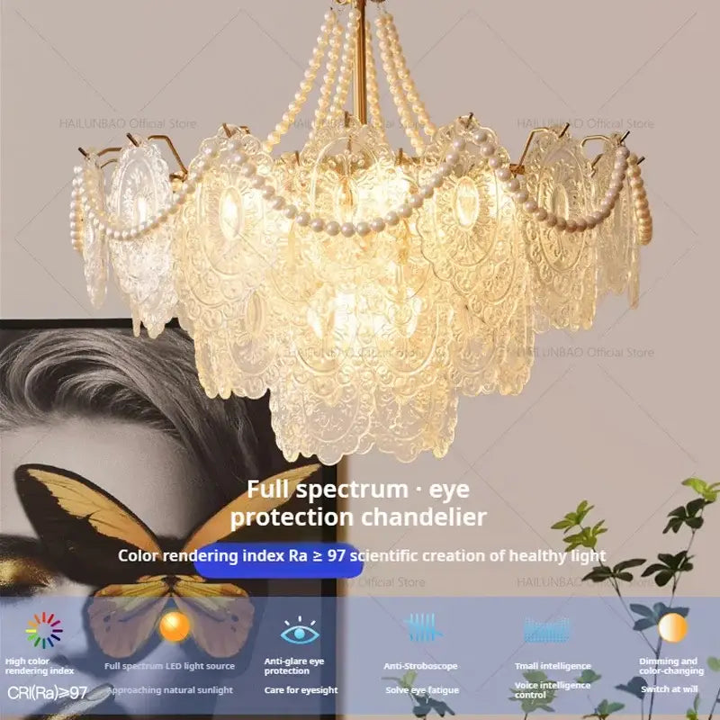 A delicate multi-tiered decorbites cream crystal chandelier with intricate lace and pearl strands for living room light
