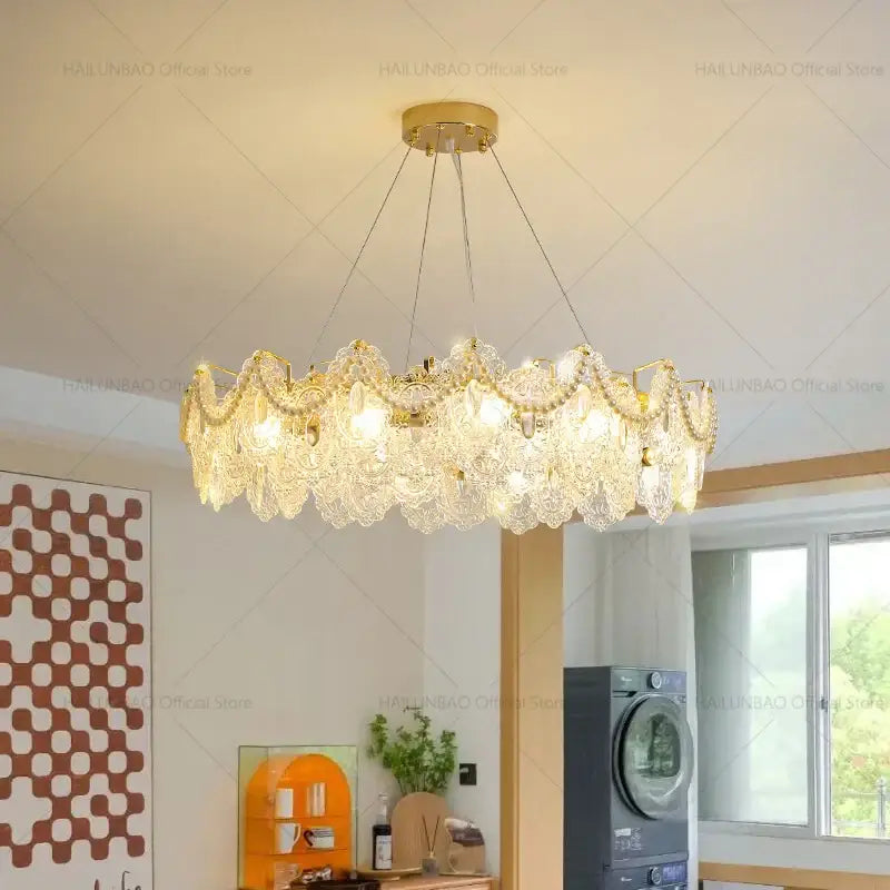 Gold-toned decorbites glass chandelier with intricate layered crystal shades in a circular pattern for dining room decor