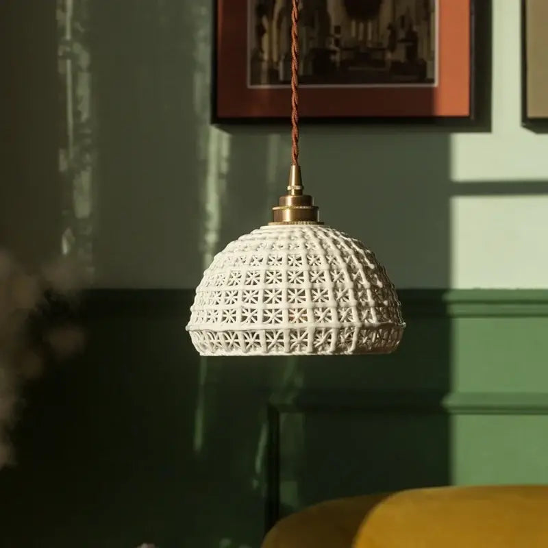 White ceramic pendant light with geometric star pattern and brass hardware for decorbites french minimalism ceramic dining room