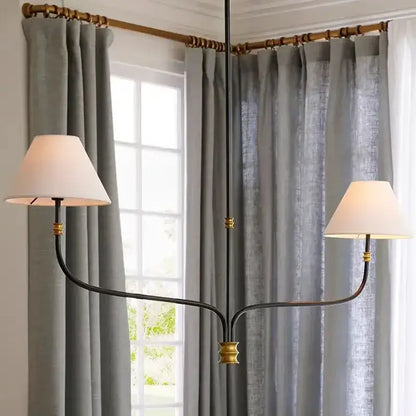 French minimalist black metal pendant light with brass accents and white fabric shades for dining room use