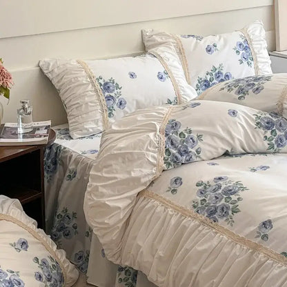 Cream-colored satin bedding set with blue floral prints and lace trim from decorbites french pastoral princess collection