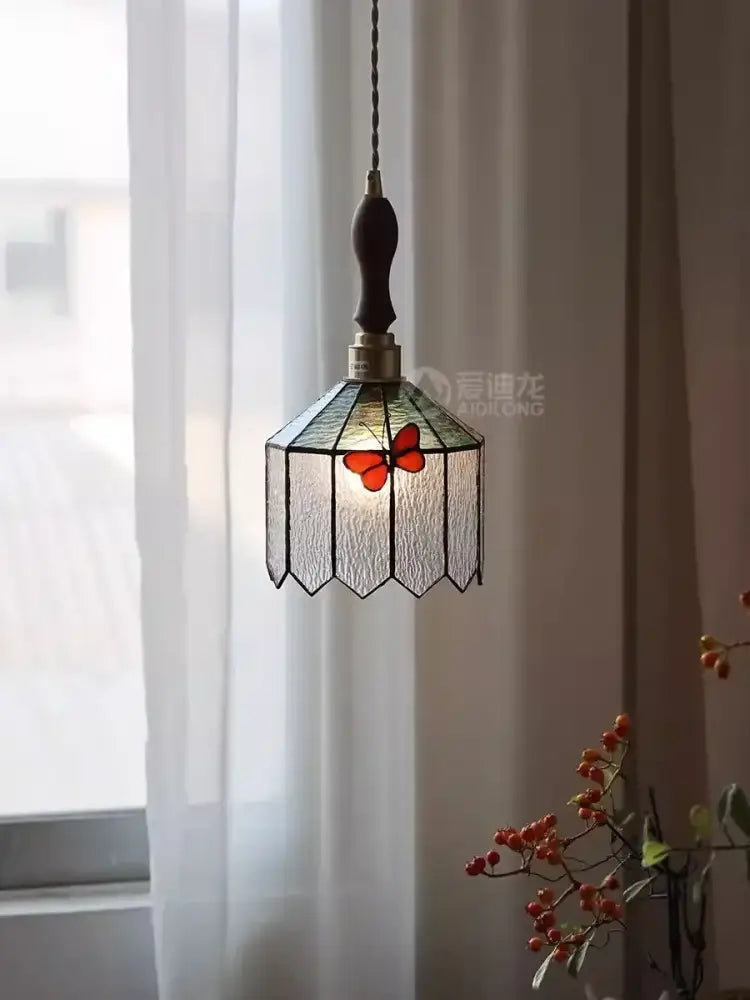 A french retro stained glass decorbites butterfly chandelier with orange butterfly motif and dark wooden handle