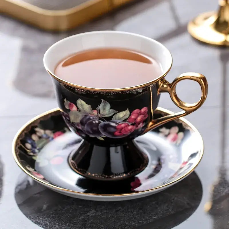 Elegant black porcelain bone china tea cup with gold trim and floral grape design from decorbites teaware set