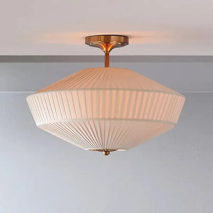 Cream-colored pleated fabric ceiling lamp with brass finish central stem by decorbites french style fabric lighting