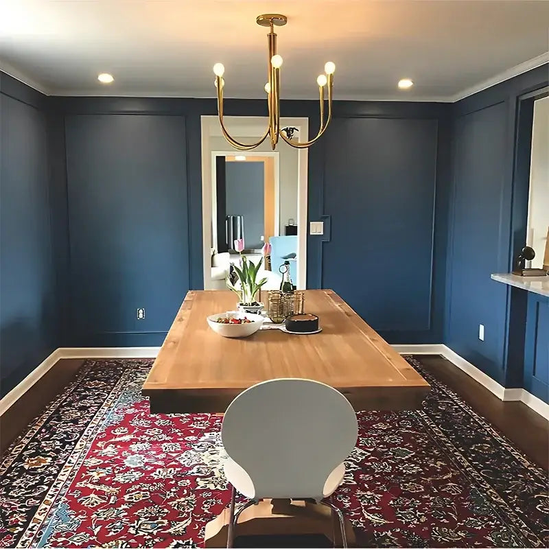 A modern gold-toned french style pendant light chandelier with multiple exposed bulbs for dining room use