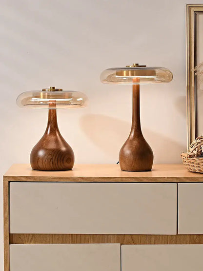 Two elegant walnut table lamps with clear glass domes and brass accents perfect for bedroom lighting