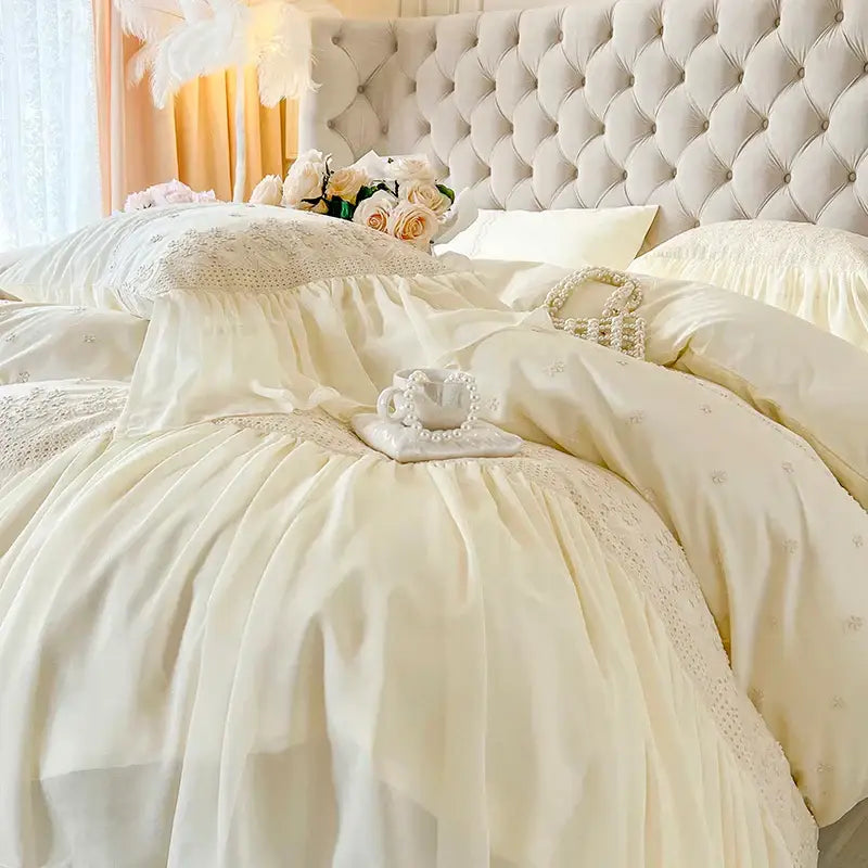 Cream-colored satin bedding set with delicate lace ruffles and subtle embroidery from decorbites french vintage collection