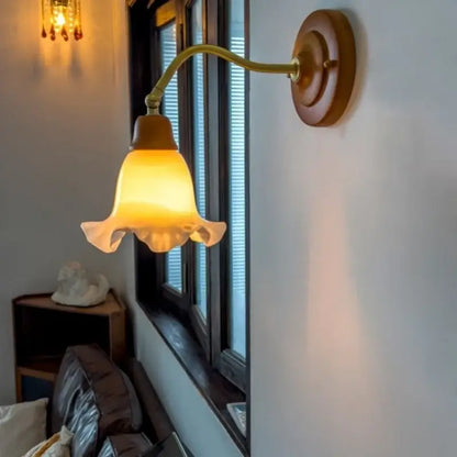 A warm amber-hued glass french vintage copper wall sconce with fluted shade and brass arm for decorbites bedroom decor