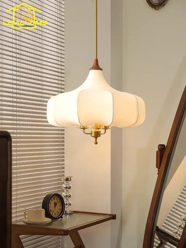 A white petal-shaped pendant light with brass finish and wooden accents for french vintage bedroom decorbites pendant lights