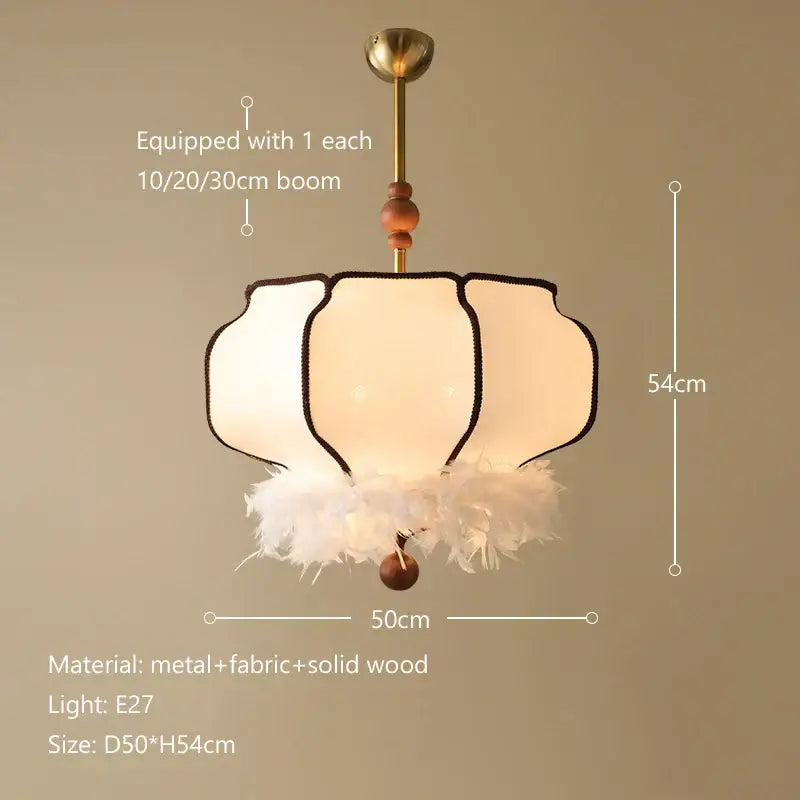 A delicate cream french vintage fabric chandelier with gold metal frame wooden accents and feather trim for dining room decorbites french vintage