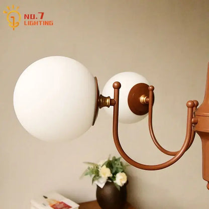 Antique brass-finished wall sconce with two frosted white glass shades for decorbites french vintage iron pendant light