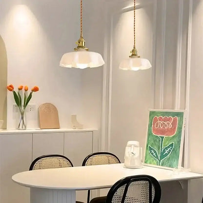 Two elegant white pendant lights with brass fixtures hang above a dining table decorbites french vintage pendant light