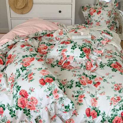 Floral-patterned bedding set with pink roses and green leaves on white background featuring lace ruffles decorbites french vintage