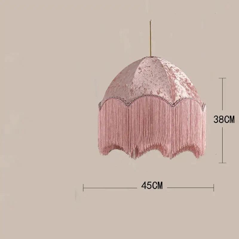 A delicate pink velvet beauvamp tassel pendant light with scalloped edge and cascading fringe for living room
