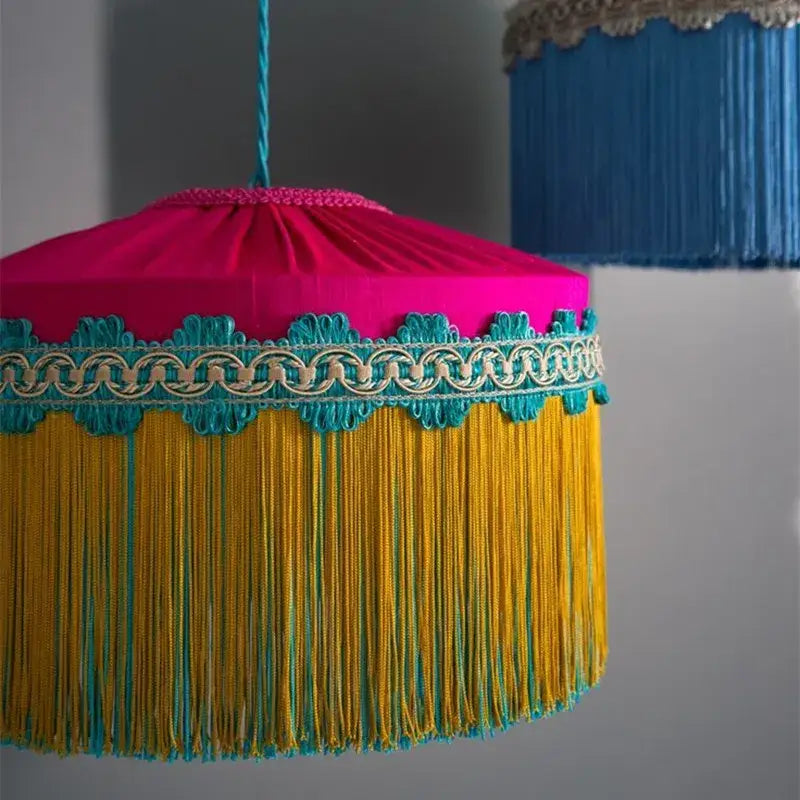 Vibrant fuchsia and gold fringe beauvamp tassel pendant light with teal trim for French vintage living room decor