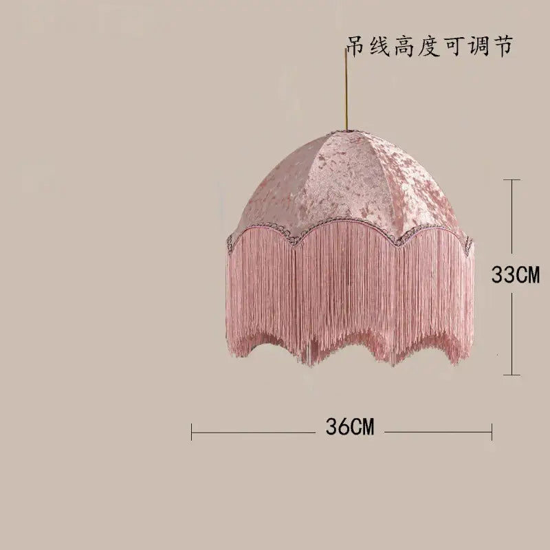 A delicate pink velvet beauvamp tassel pendant light with cascading fringe detailing for a living room