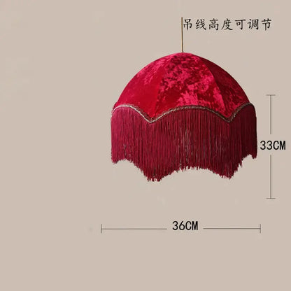 A plush deep red velvet pendant light with gold scalloped edge and long fringe for living room decor tassel pendant light
