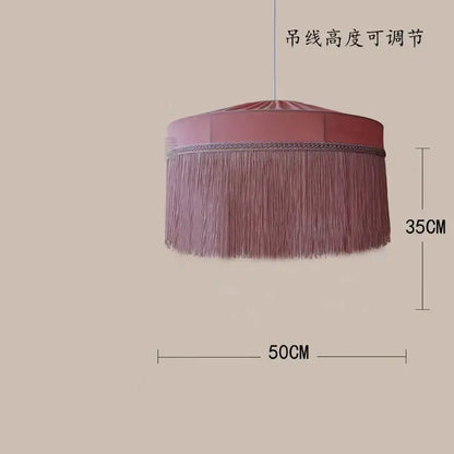 A soft pink satin fabric beauvamp tassel pendant light with delicate fringes for living room decor