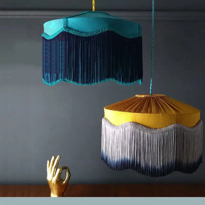 Two ornate french vintage beauvamp tassel pendant lights in teal and mustard with decorative fringe for living room use