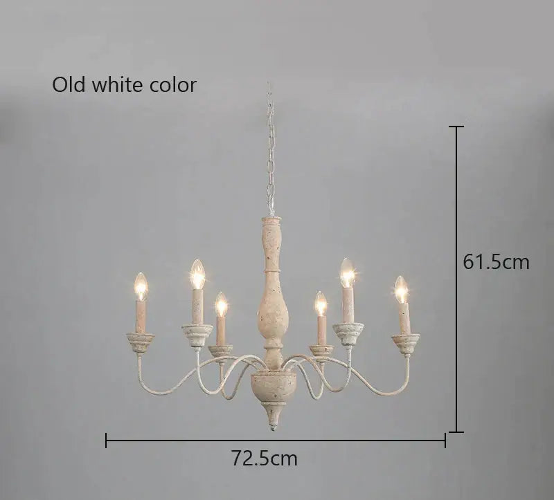 Old white distressed french vintage wooden chandelier with five candle-style lights and chain suspension for dining room decor