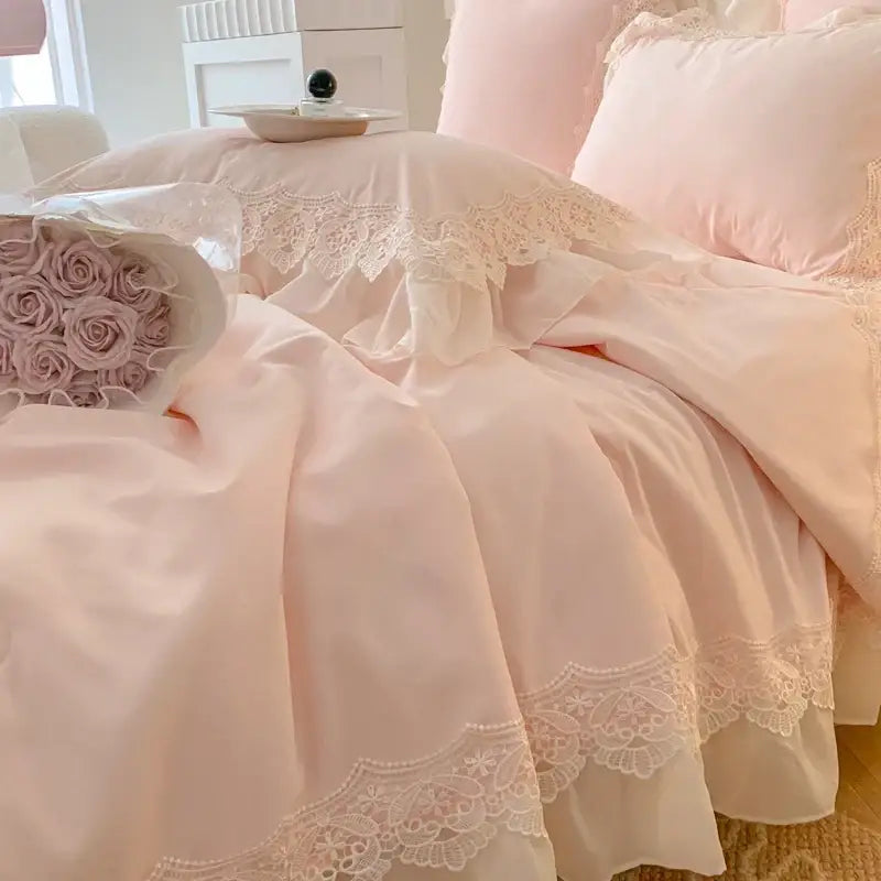Pastel pink ruffled bedding set with delicate white lace trim featuring floral embroidery for decorbites french wedding lace