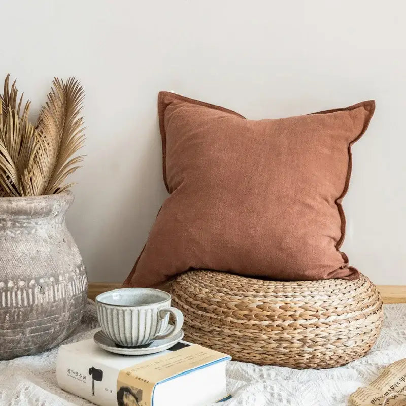 A rust-colored soft linen pillow cover with subtle texture and neatly stitched edges for decorbites linen pillow decor
