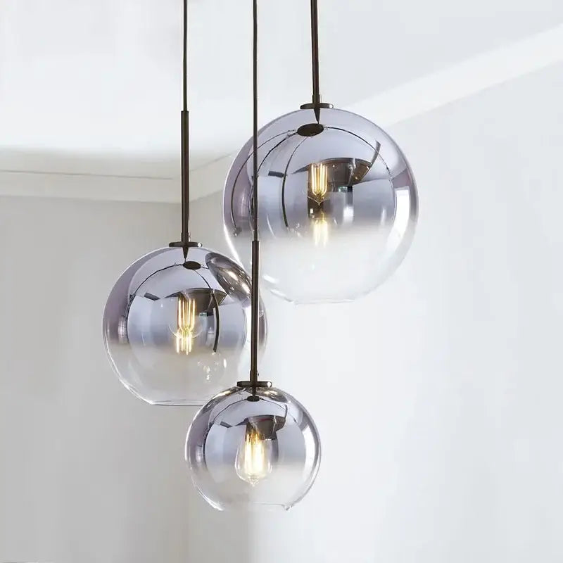 Three spherical frosted and mirrored glass ball pendant lights with exposed filament bulbs for dining room decorbites pendant light