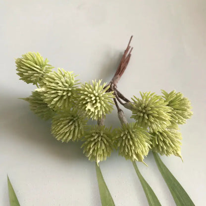 A cluster of artificial light green spiky spherical flowers with brown stems in a greenery berry stamen bundle for decorbites