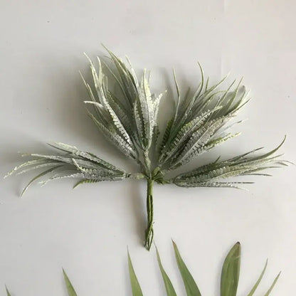 Frosty green artificial palm frond with delicate feathery leaves and textured stem in greenery berry stamen bundle decorbites