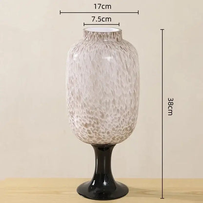 A tall frosted marbled dot texture glass vase with a black pedestal base for living room decor by decorbites dot texture