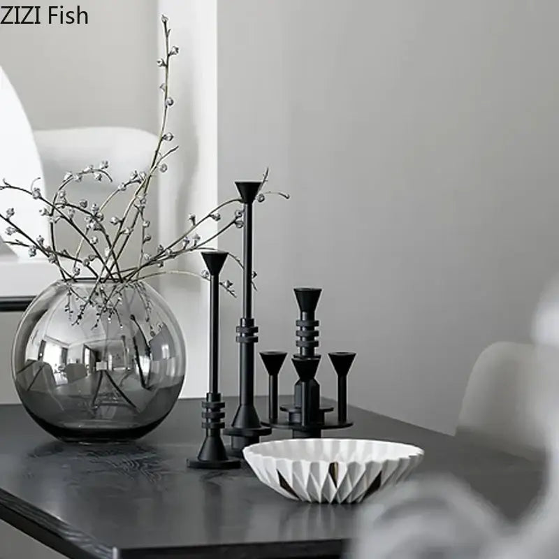 A sleek round glass vase with delicate white berries complements decorbites frosted metal candle holder for romantic dining decor