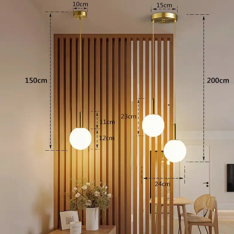 Three modern globe pendant lights with frosted white glass and smoke gray gold-finished fixtures for dining room