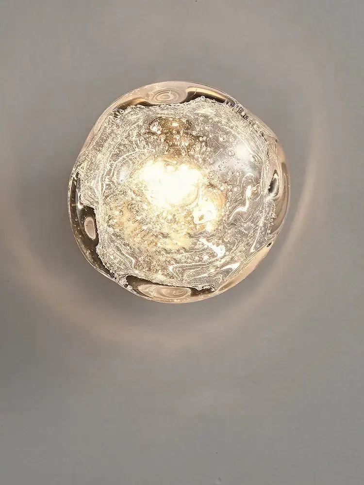 Galaxy blue and amber translucent bubble-filled glass wall sconce lamps emitting a warm glow for living room lighting