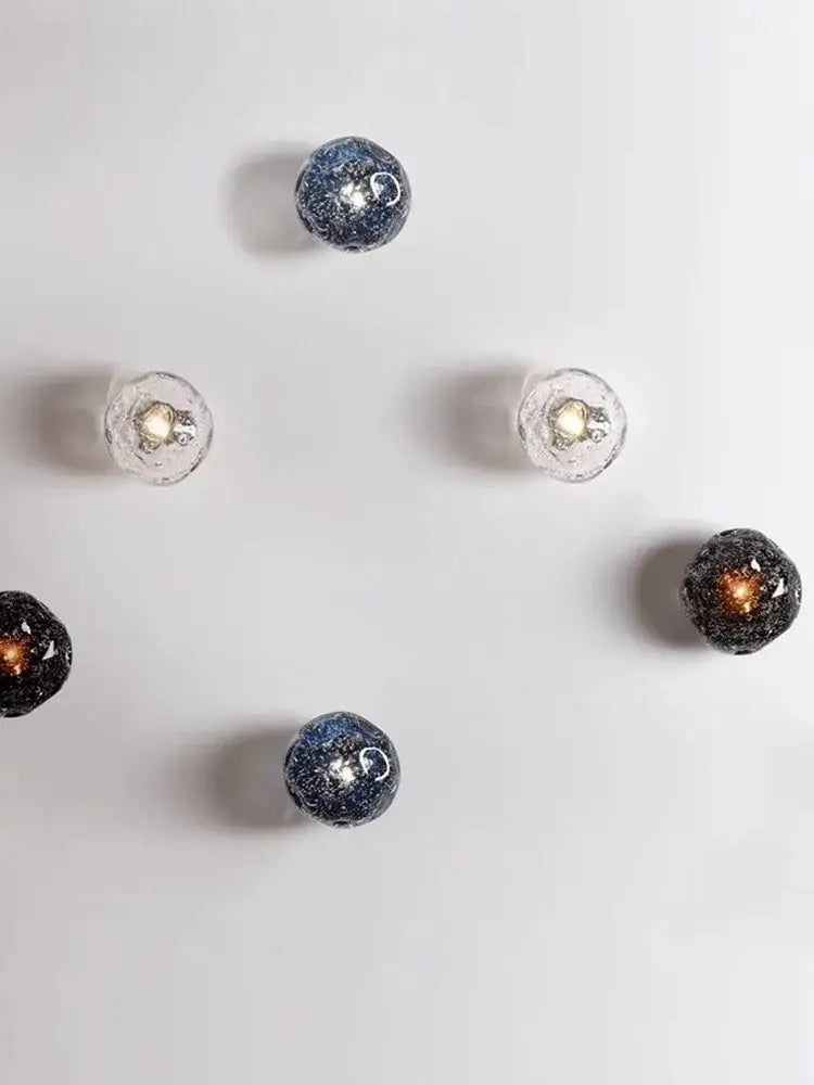 Galaxy blue and amber glass wall sconce lamps feature spherical glass with embedded glitter for living room lighting