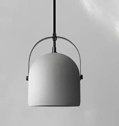 Minimalist gray concrete pendant light with dome-shaped shade and curved frame for dining room glass pendant light