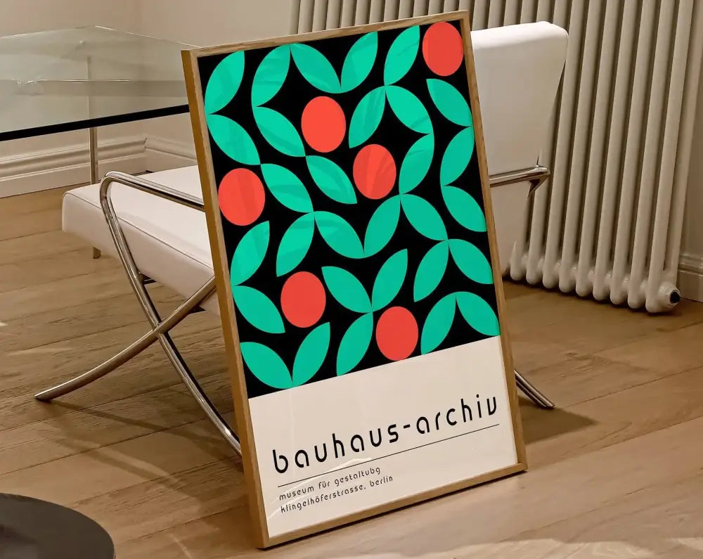 A framed decorbites™ mid century bauhaus art canvas with teal leaves red circles and bauhaus-archiv text on black background