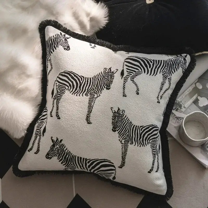 Square white jacquard pillow cover set with black zebra silhouettes and fringed black border for living room