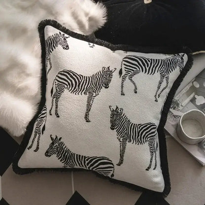 Square white jacquard pillow cover set with black zebra silhouettes and fringed black border for living room
