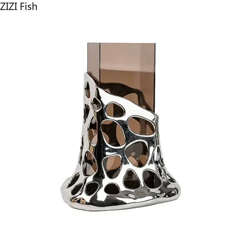 Silver metallic decorbites gold plated vase with sculpted hollowed design holding tall amber glass for living room decor
