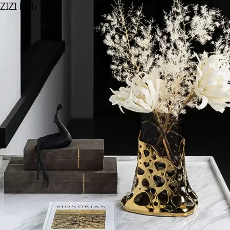 Geometric black and gold plated hollowed ceramic vase with perforated design and black marble accents for decorbites gold plated decor