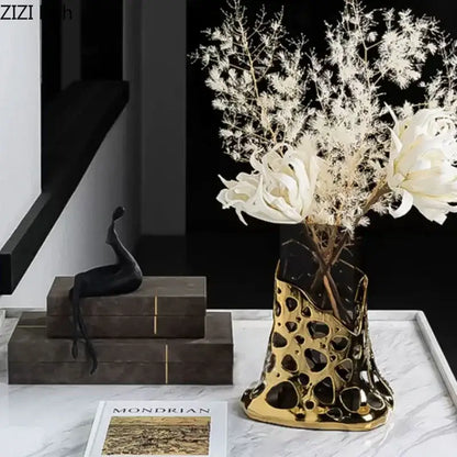Geometric black and gold plated hollowed ceramic vase with perforated design and black marble accents for decorbites gold plated decor