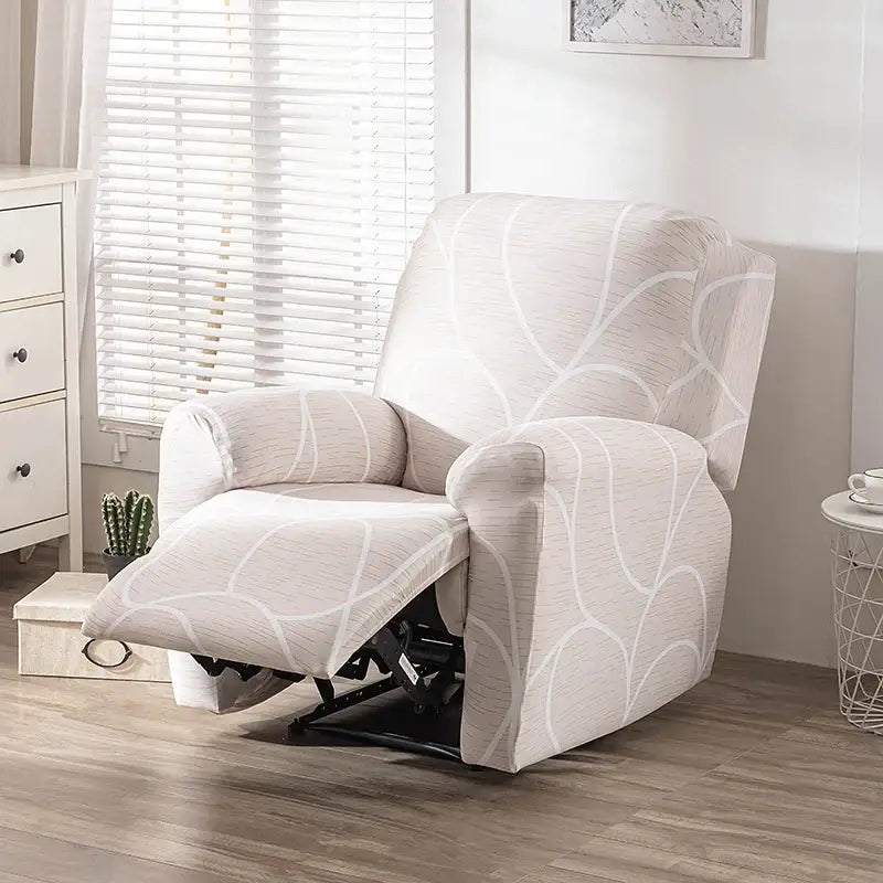 Beige recliner chair with white abstract leaf pattern fabric cover shown with geometric black and red stretch recliner cover