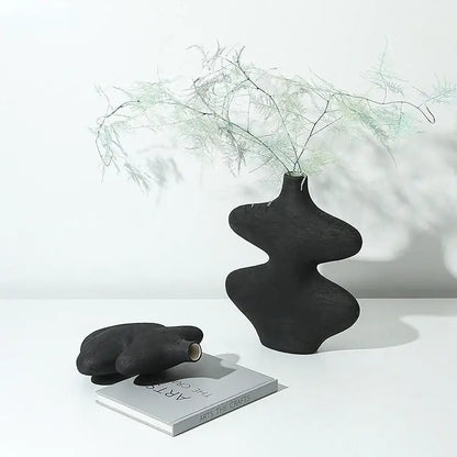 Black ceramic vase with organic sculptural curves and matte finish in geometric ceramic vase set for living room decorbites decor