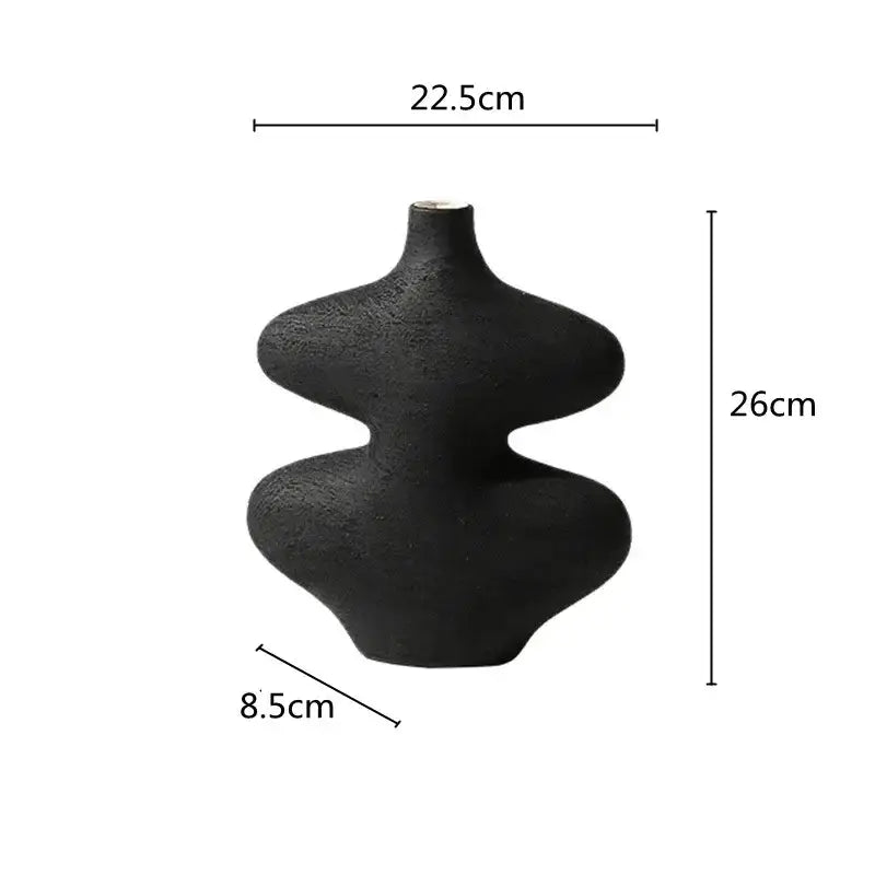 A sleek matte black geometric ceramic vase with hourglass silhouette from decorbites ceramic vase set for living room decor