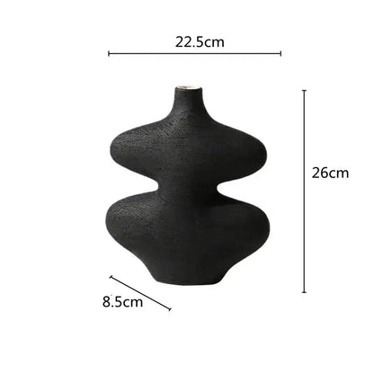 A sleek matte black geometric ceramic vase with hourglass silhouette from decorbites ceramic vase set for living room decor