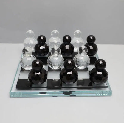 Black and clear faceted glass checkers on transparent glass chess set for geometric blue and clear glass chess living room decor