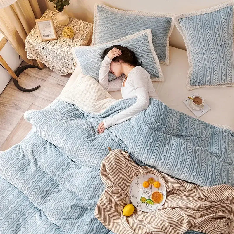 Soft blue coral fleece flannel blanket with geometric designs and cozy textured fabric for warm bedroom decorbites use