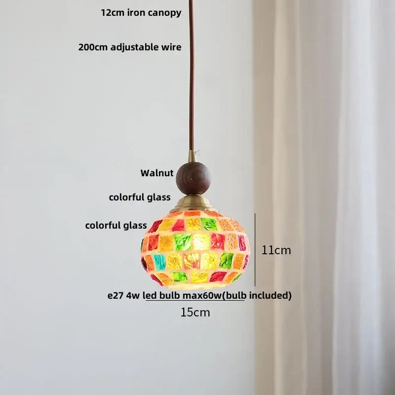 A vibrant mosaic glass pendant light with walnut finish and brass accents featuring colorful stained-glass panels